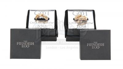 Lot #279 - GAME OF THRONES (TV SERIES, 2011-2019) - Two Gold Cast and Crew Gift Dragon and Direwolf Rings
