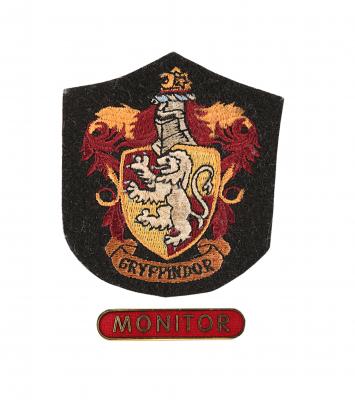 Lot #166 - HARRY POTTER AND THE DEATHLY HALLOWS: PART 2 (2011) - Gryffindor House Patch and "Monitor" Badge