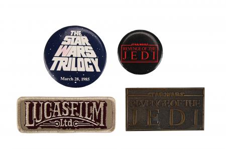 Lot #933 - STAR WARS: ORIGINAL TRILOGY (1977-1983) - Brass Paperweight Crew Gift, Lucasfilm Ltd Embroidered Patch and Badges